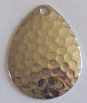 A gold colored metal tear drop shaped pendant.