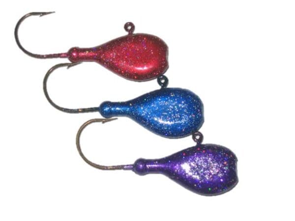 A group of three different colored fish hooks.