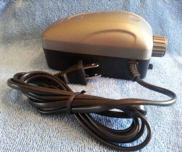 A power cord is attached to the side of an electric device.